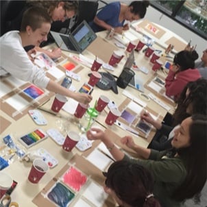 Rover teammates painting together in a group activity they organized.