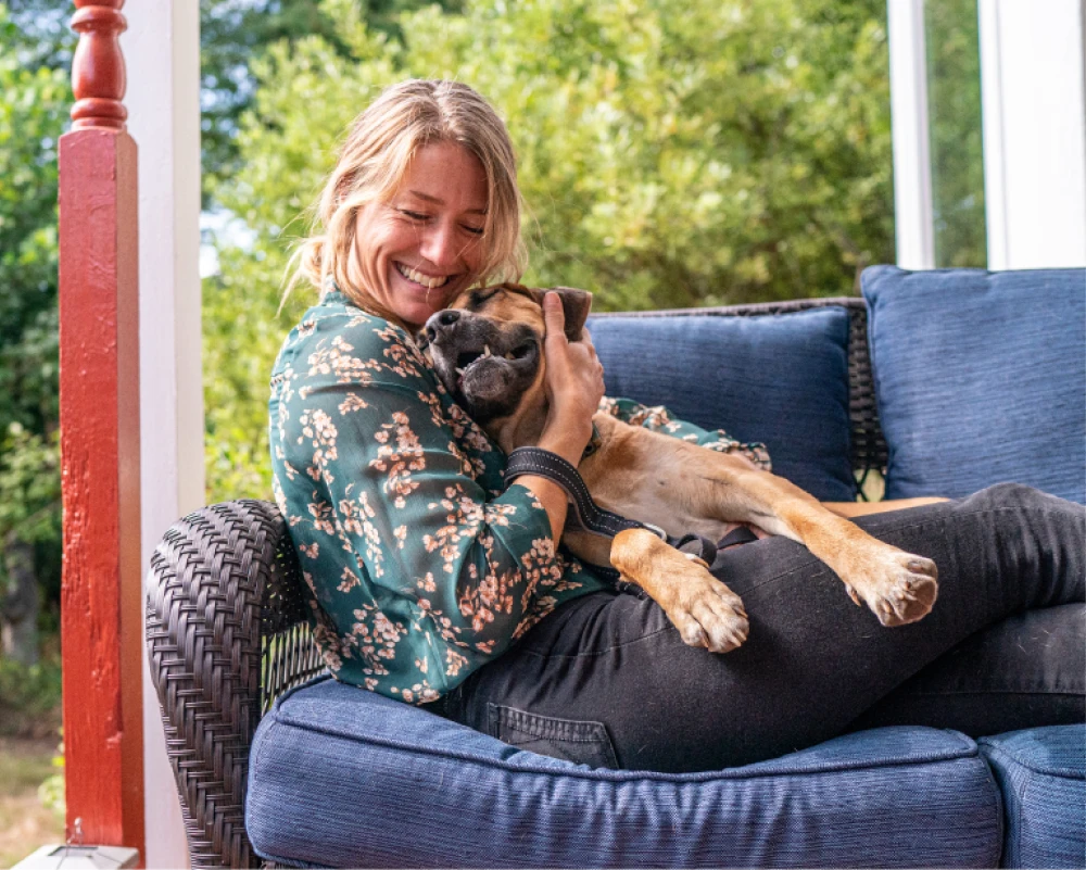 Person hugging dog