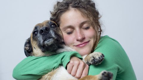 Woman hugs dog - Rover search