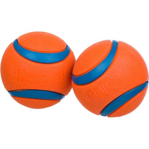 a pair of orange and blue Kong indestructible dog ball toys