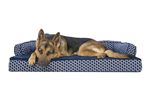 German Shepherd lying on blue-and-white patterned Furhaven couch dog bed