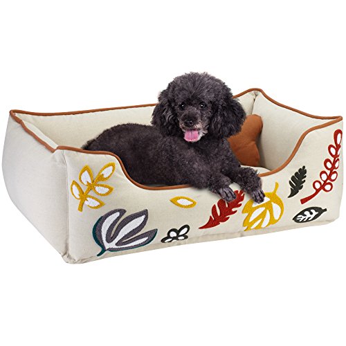 black dog on Blueberry Pet cream bolstered bed with flower embroidery