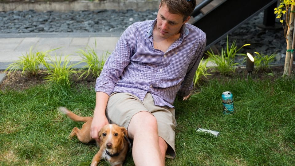 A man and his adopted dog relaxing outside.