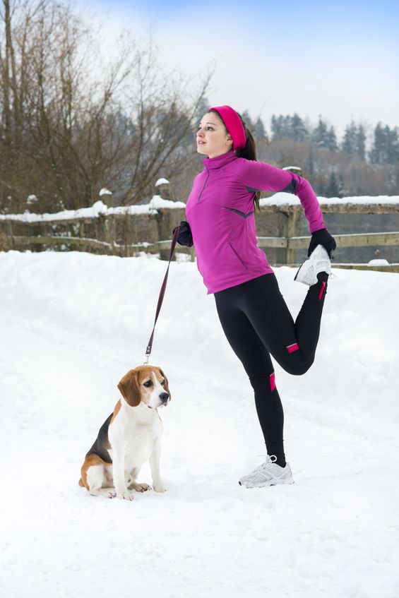 Woman stretching with dog - 123RF