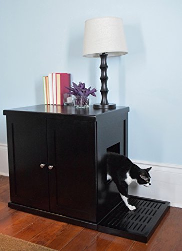 black and white cat coming out of black sideboard