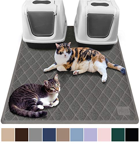 two cats and litter boxes on Gorilla Grip mat