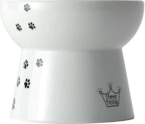White ceramic elevated cat food bowl with decorative paw prints