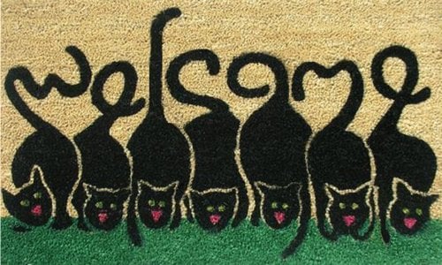 doormat with cats whose tails spell out "welcome"