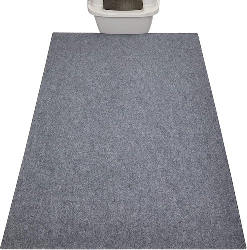 A large grey cat litter mat with a litter box on the end.