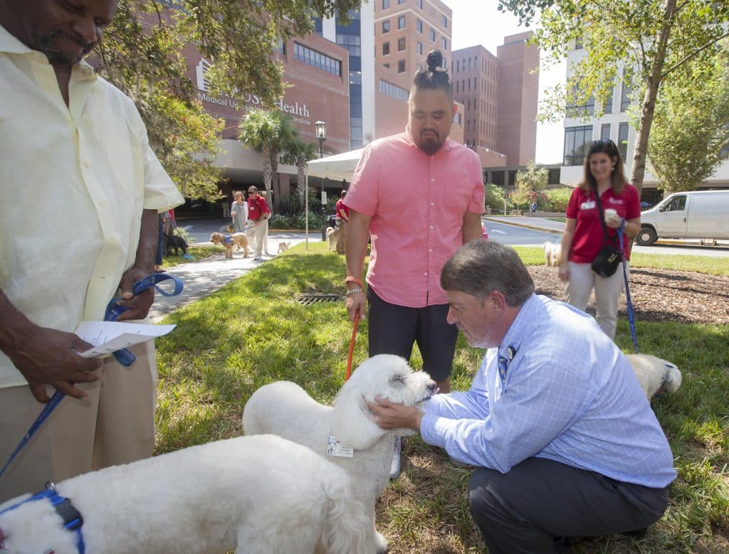 Chaplain George Rossi blesses a therapy dog