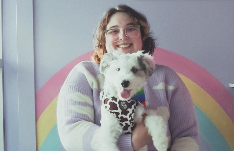 Cloudberry Grooming owner Julia holding a happy, well-groomed dog