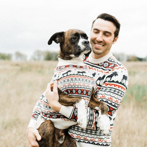 man holding dog, both wearing Dog Threads Great Yukon Sweater from "Shark Tank"