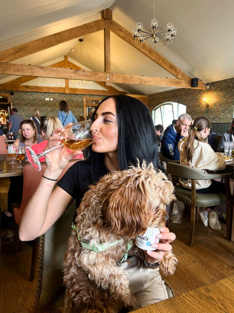 Woman and her dog at the Middle Inn, Bamburgh