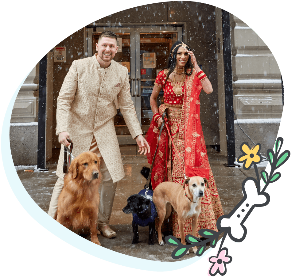 A picture of a married couple who included their two dogs in their wedding day for photos