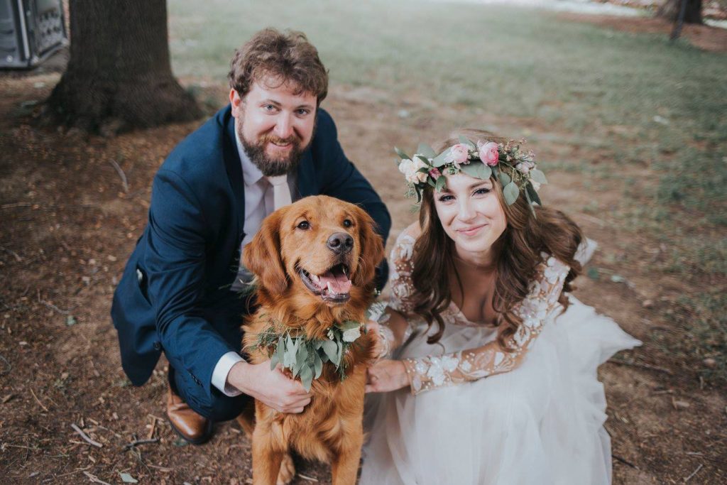 A couple on their wedding day, who hired a sitter on Rover to help them include their Golden Retriever in the ceremony