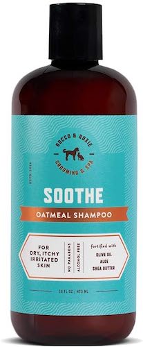 A teal and dark brown bottle of dog shampoo. 