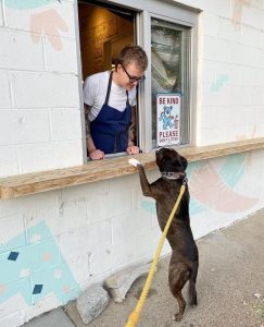 A dog stands at the open window of Redheaded Stranger restaurant