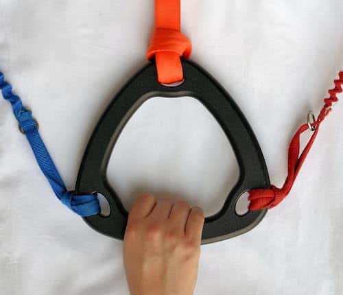 A hand holding on to a multi-leash dog attachment. 