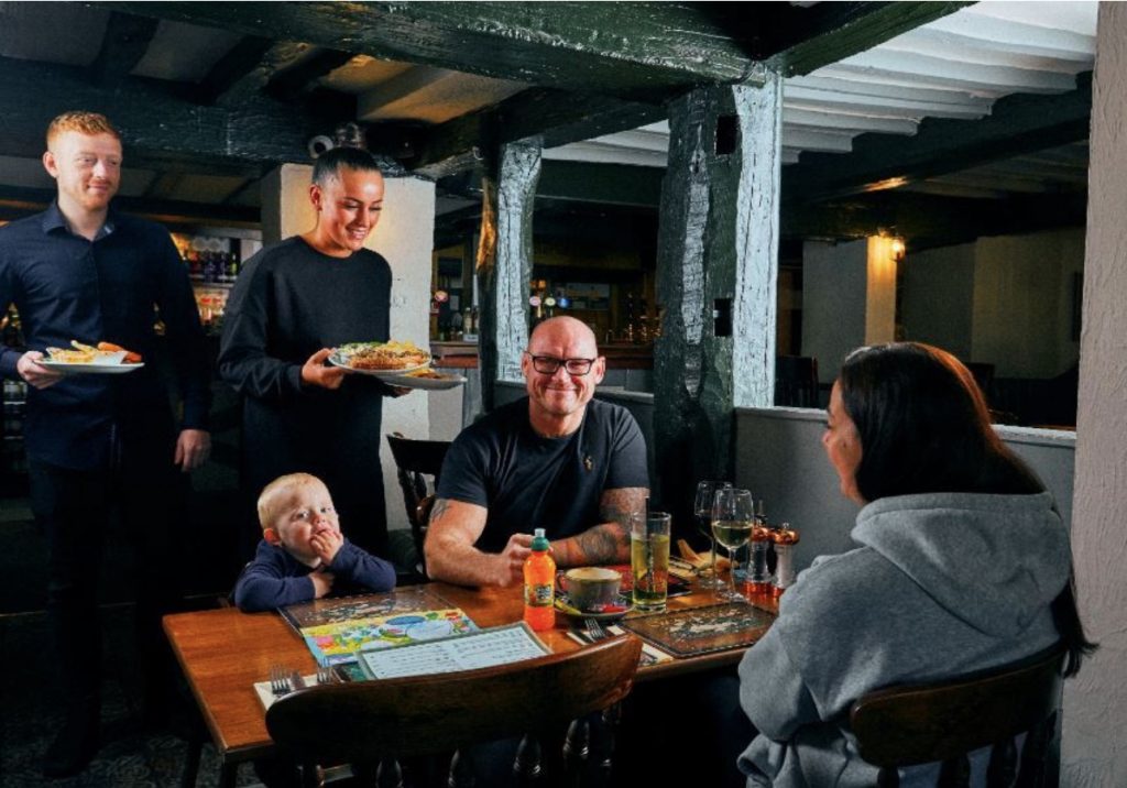 People at a London pub enjoying their meal