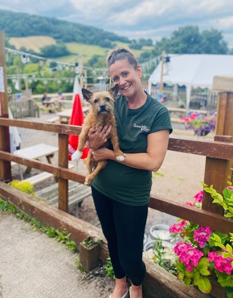 A woman holding a dog at the Goose & Cuckoo Inn