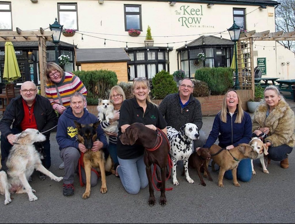 Group of people with their dogs at The Keel Row, Seaton Delaval