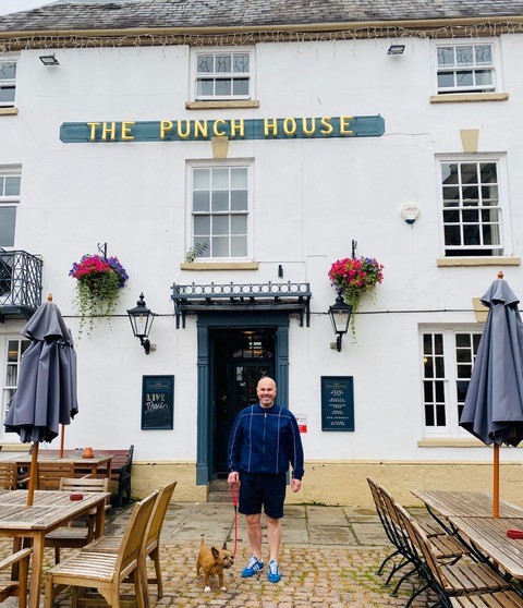 A man and his dog outside The Punch House