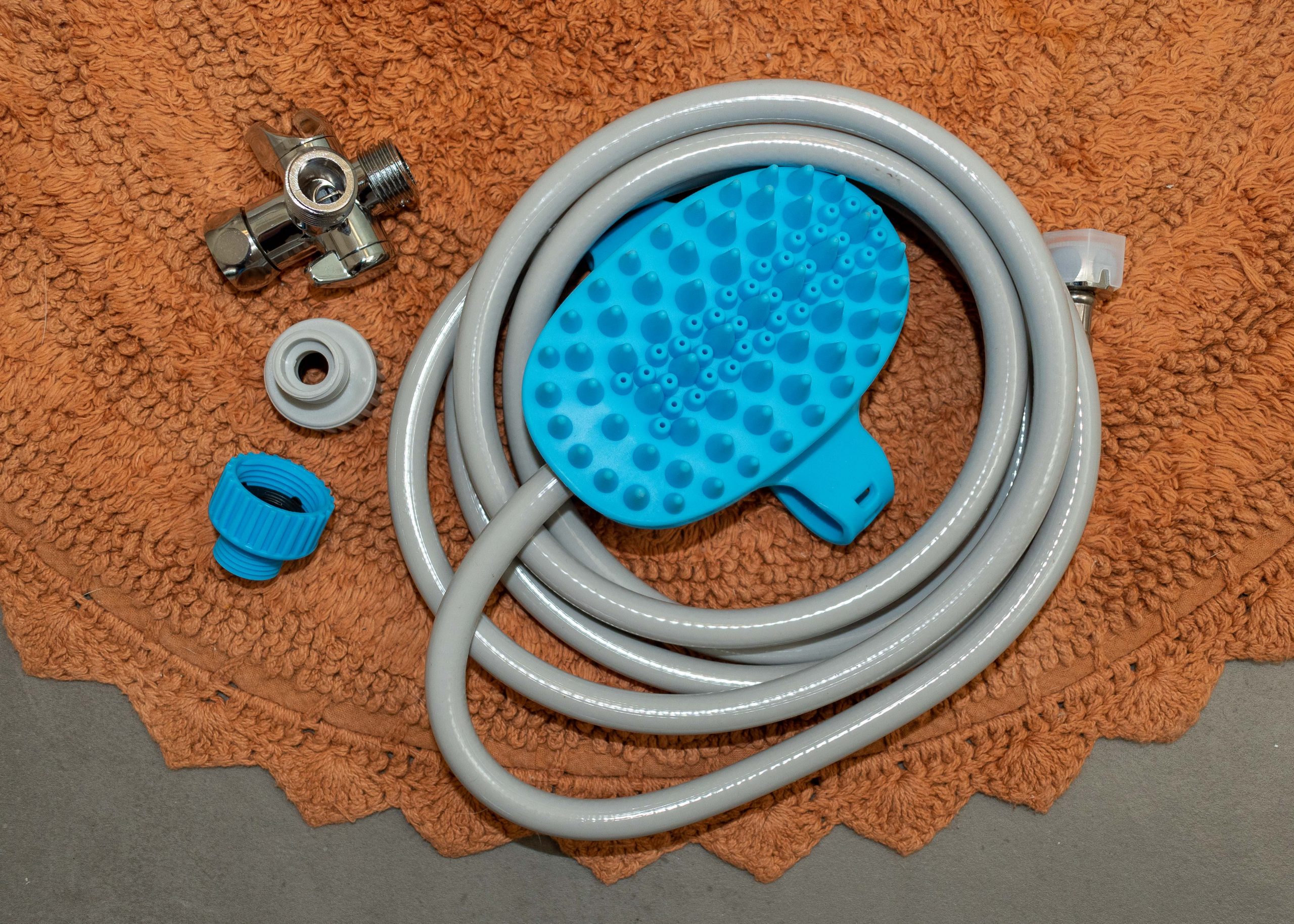 Aquapaw with attached hose, shower adaptor, and garden hose adaptors