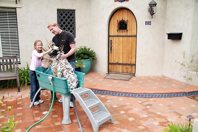 Family washing dog in portable Booster Elevated Dog Bath
