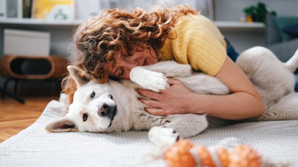 Person lying on floor with dog