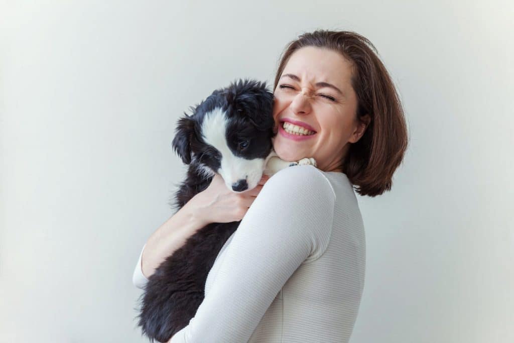 Woman holding her new puppy