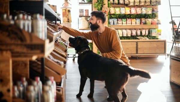 Young Man And His Dog Explore the Pet Store