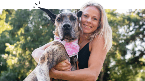 Woman hugs big dog in park