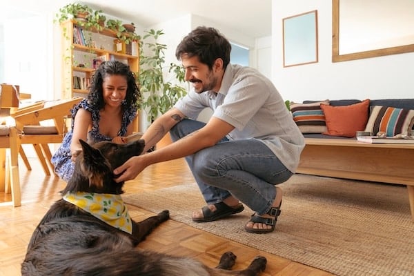 Woman introducing man to dog in home