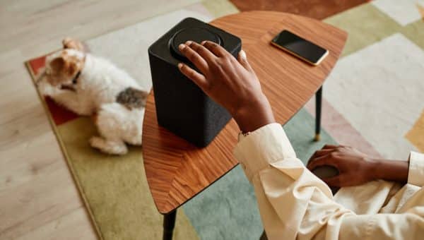 Black woman using speakers to play noises for her dog