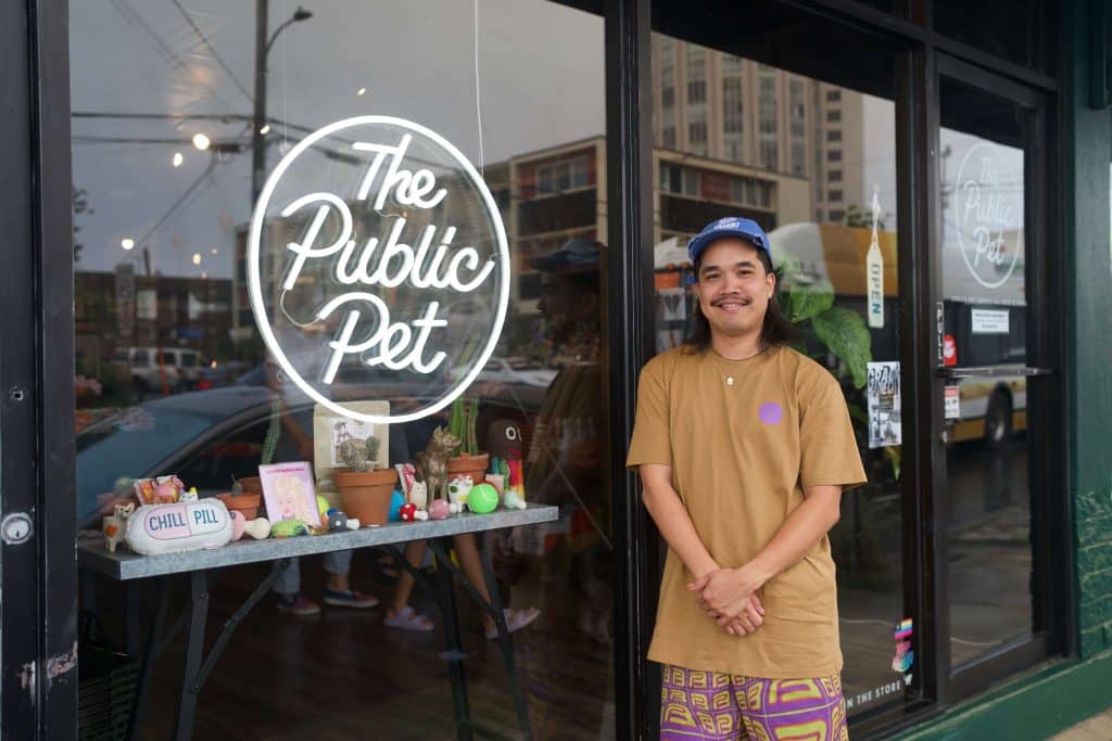 Jordan Lee, owner of The Public Pet, posing at his hip store front