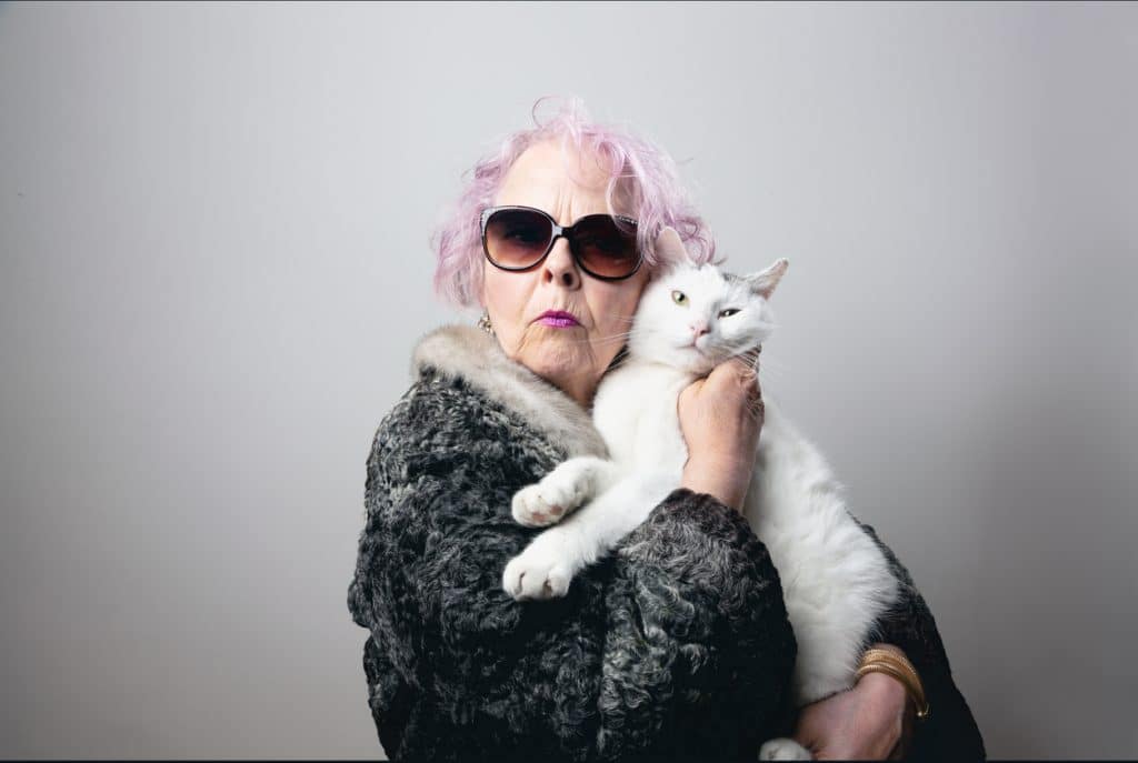 Older adult lady holding her cat 