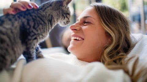 Women with her cat share tenderness